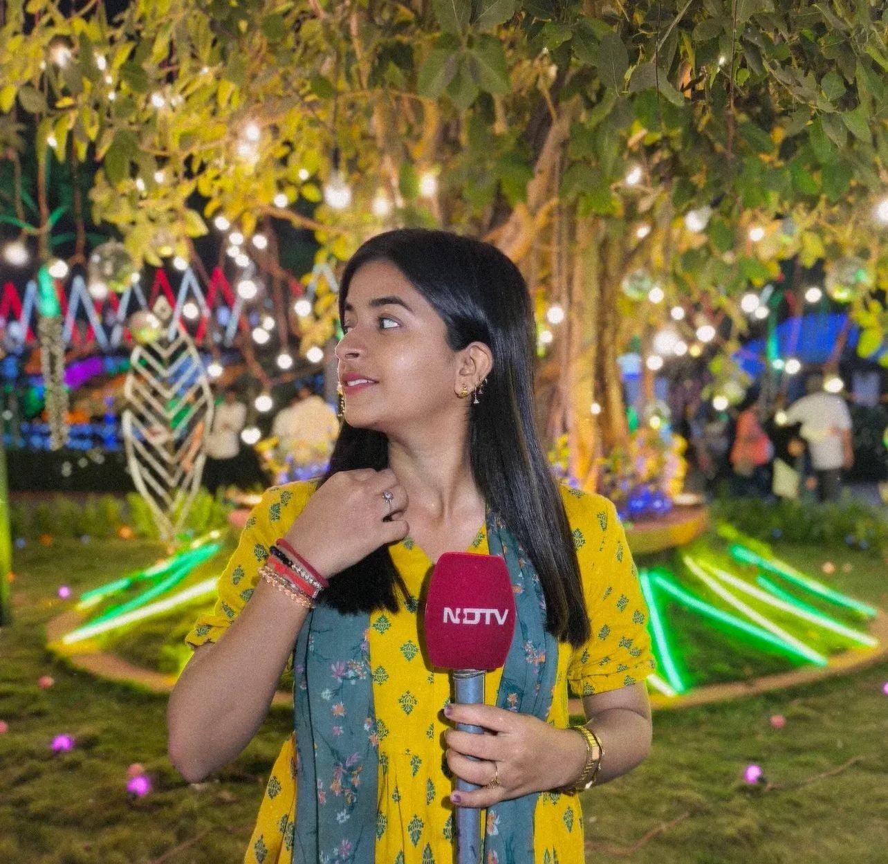 Sujata Dwivedi reporting at an evening public event for NDTV
